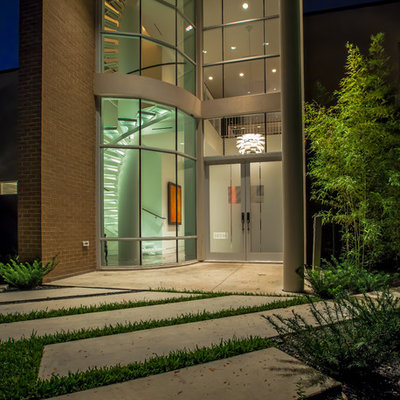 Example of a trendy entryway design in Dallas with a glass front door