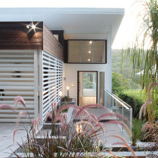 Inspiration for a large contemporary front door in Gold Coast - Tweed with white walls, a single front door, a glass front door and grey floor.