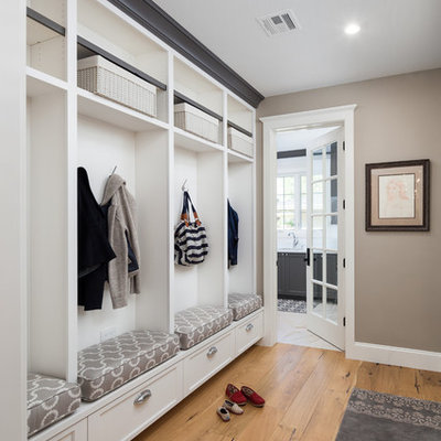 Mid-sized transitional light wood floor mudroom photo in Phoenix with beige walls