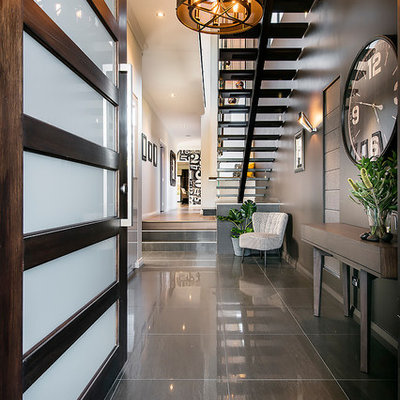 Example of a trendy gray floor entryway design in Perth with black walls and a dark wood front door