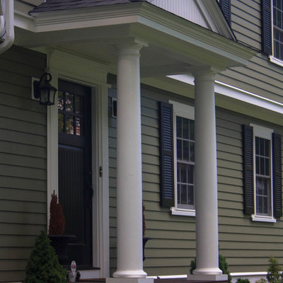 Inspiration for a mid-sized timeless front door remodel in Boston with green walls and a black front door