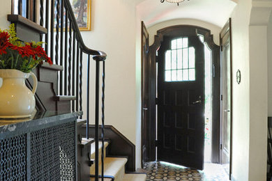 Entryway - mediterranean entryway idea in Columbus with white walls and a black front door