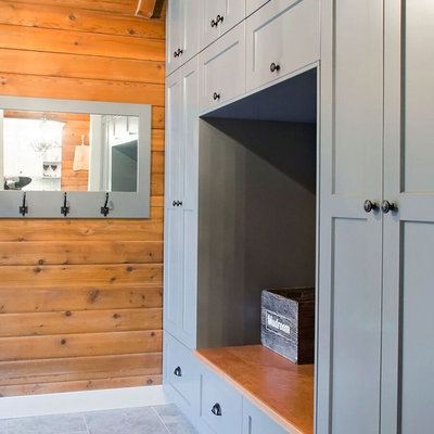 Inspiration for a large farmhouse ceramic tile and brown floor mudroom remodel in Vancouver
