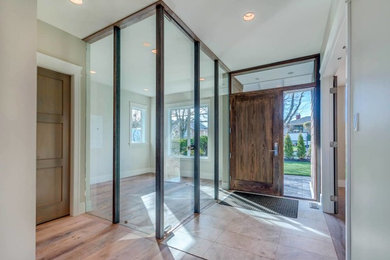 Example of a mid-sized trendy porcelain tile and beige floor entryway design in Vancouver with beige walls and a dark wood front door