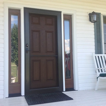 Cherry stained Fiberglass entry door and storm door for a country farmhouse in C