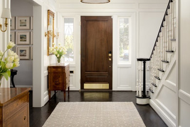 Inspiration for a medium sized classic foyer in DC Metro with white walls, dark hardwood flooring, a single front door, a dark wood front door and brown floors.