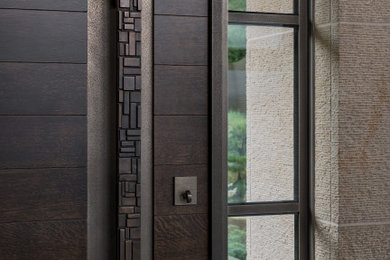 Entryway - large contemporary entryway idea in Seattle with a dark wood front door