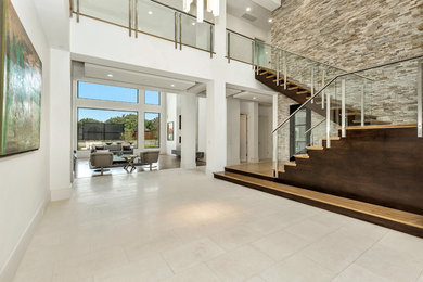 Foyer - huge contemporary limestone floor and beige floor foyer idea in Dallas