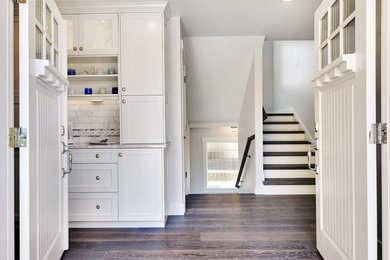 Small transitional medium tone wood floor entryway photo in Seattle with white walls and a white front door