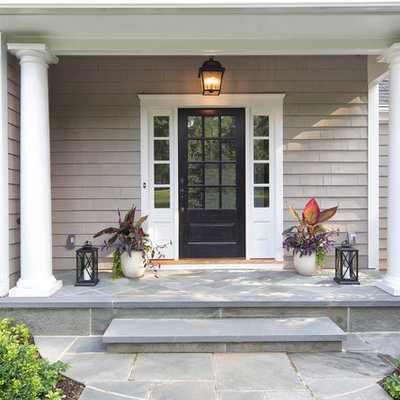 Entryway - traditional slate floor and gray floor entryway idea in New York with gray walls and a black front door