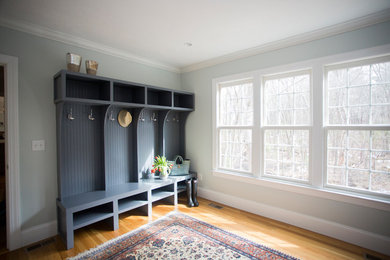 Inspiration for a transitional light wood floor mudroom remodel in Boston