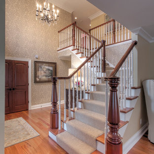 Example of a large classic medium tone wood floor entryway design in Other with yellow walls and a glass front door