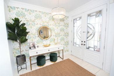 Example of a large trendy porcelain tile and white floor entryway design in Toronto with white walls and a white front door
