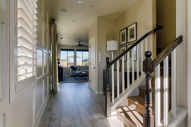 Mid-sized country medium tone wood floor and gray floor foyer photo in Los Angeles with gray walls