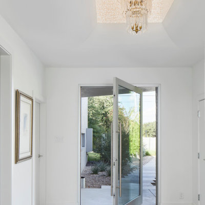 Example of a trendy entryway design in Austin with white walls