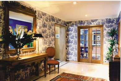 Inspiration for a mid-sized eclectic marble floor entryway remodel in Other with blue walls and a light wood front door