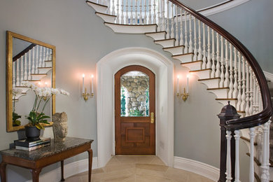 Example of a classic entryway design in Bridgeport with gray walls and a medium wood front door