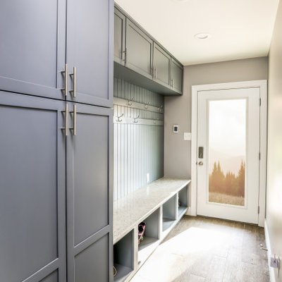 Entryway - mid-sized transitional light wood floor and beige floor entryway idea in DC Metro with gray walls and a white front door