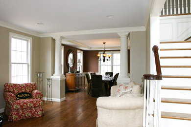 Foyer - transitional medium tone wood floor foyer idea in Providence with beige walls