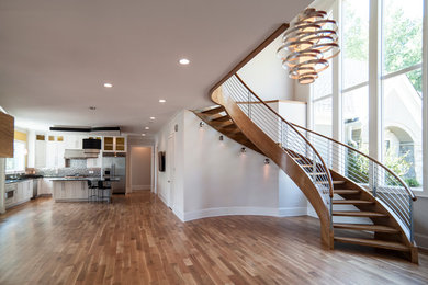 Inspiration for a large contemporary medium tone wood floor foyer remodel in Charlotte with beige walls