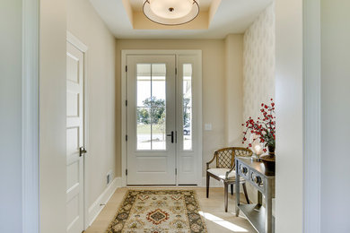 Example of a mid-sized transitional light wood floor entryway design in Minneapolis with beige walls and a white front door