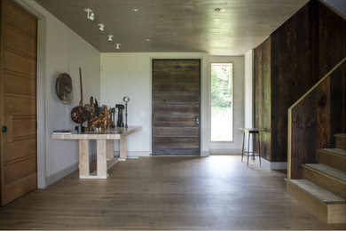 Mid-sized minimalist light wood floor entryway photo in Bridgeport with white walls and a dark wood front door