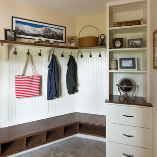 Inspiration for a mid-sized farmhouse slate floor and brown floor mudroom remodel in Portland Maine with beige walls