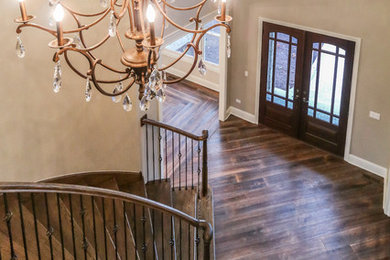 Entryway - large traditional dark wood floor and brown floor entryway idea in Other with beige walls and a glass front door
