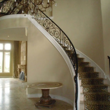 Curving wrought iron staircase with leopard print rug