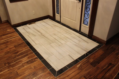 Entryway - mid-sized traditional medium tone wood floor entryway idea in Wichita with white walls and a white front door