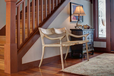 Photo of a medium sized classic front door in Seattle with beige walls, medium hardwood flooring and feature lighting.