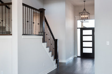 Inspiration for a contemporary dark wood floor and brown floor single front door remodel in Wichita with gray walls and a brown front door