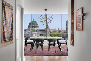 Example of a mid-sized trendy light wood floor dining room design in St Louis with white walls