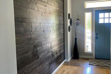 Entryway - wood wall entryway idea in Other with black walls