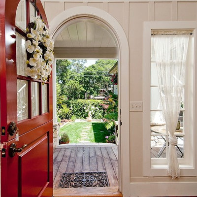 Inspiration for a mid-sized timeless light wood floor entryway remodel in Seattle with beige walls and a red front door