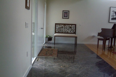 Inspiration for a large transitional granite floor entryway remodel in New York with a white front door and white walls