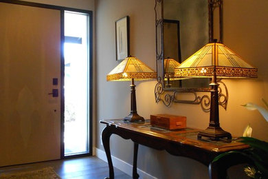Single front door - eclectic single front door idea in Los Angeles with a light wood front door