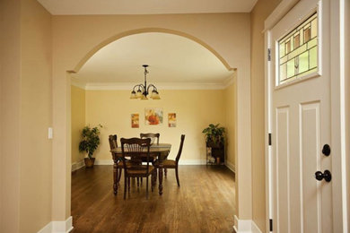 Medium tone wood floor dining room photo in Grand Rapids with beige walls