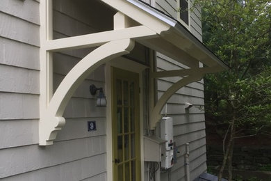 Example of a mid-sized cottage entryway design in Boston with a green front door