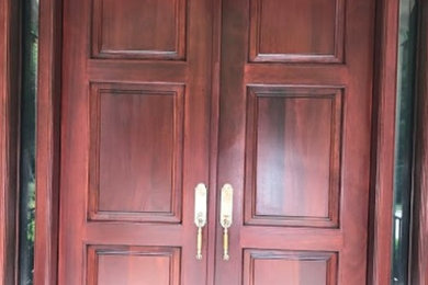 Ejemplo de entrada pequeña con puerta doble y puerta de madera oscura