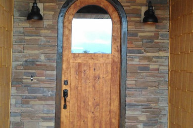Entryway - small rustic entryway idea in Other with a light wood front door