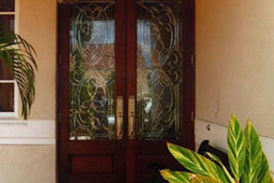 Diseño de puerta principal grande con paredes beige, puerta doble y puerta de madera oscura