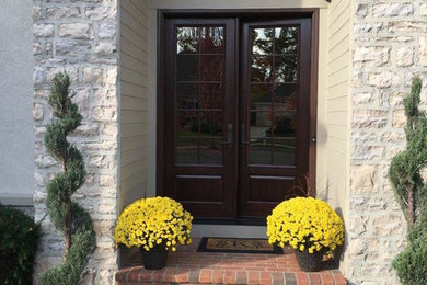 Entryway - large traditional entryway idea in Columbus with a black front door