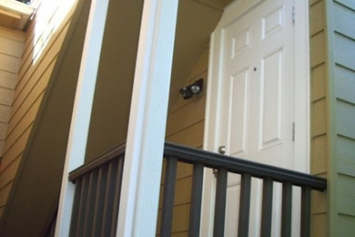 Example of a single front door design in Seattle with beige walls and a white front door