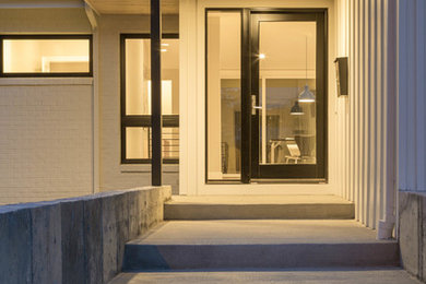 Example of a mid-sized minimalist entryway design in Denver