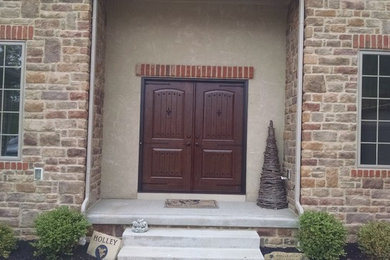 Example of a mid-sized mountain style entryway design in Columbus with a dark wood front door