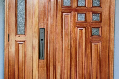 Foto de puerta principal clásica renovada de tamaño medio con paredes grises, puerta simple y puerta de madera en tonos medios