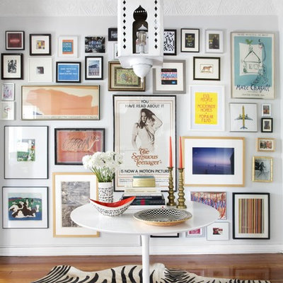 Example of an eclectic medium tone wood floor foyer design in Los Angeles with white walls