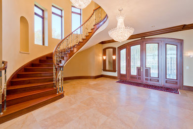 Inspiration for a timeless marble floor entryway remodel in Minneapolis with beige walls and a medium wood front door