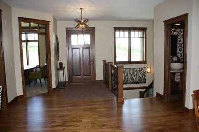 Inspiration for a craftsman medium tone wood floor entryway remodel in Other with a medium wood front door